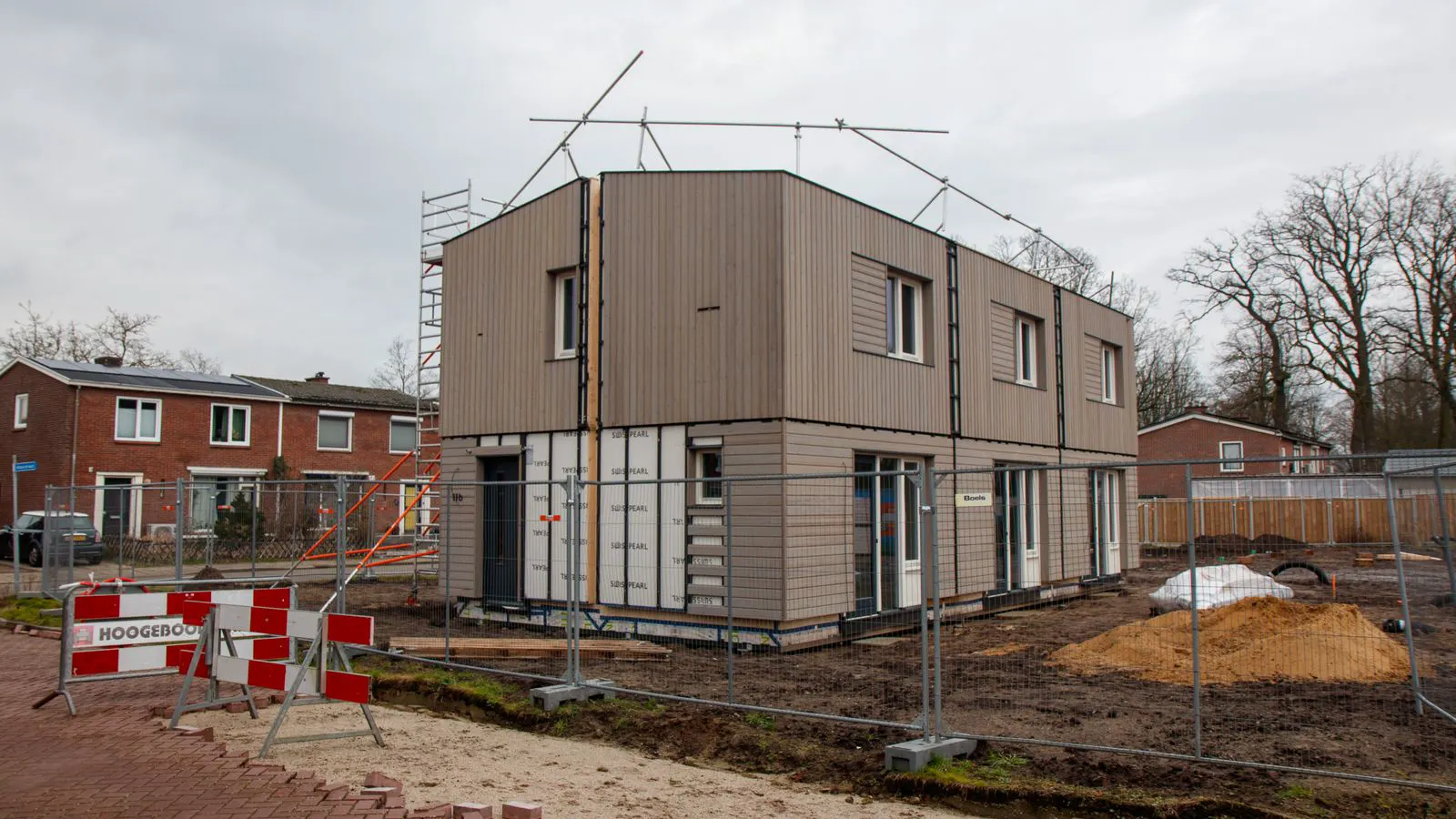 A modular building section parked on a prepared concrete pad