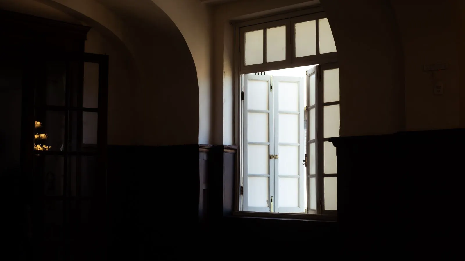 Worker installing new window frame inside a room