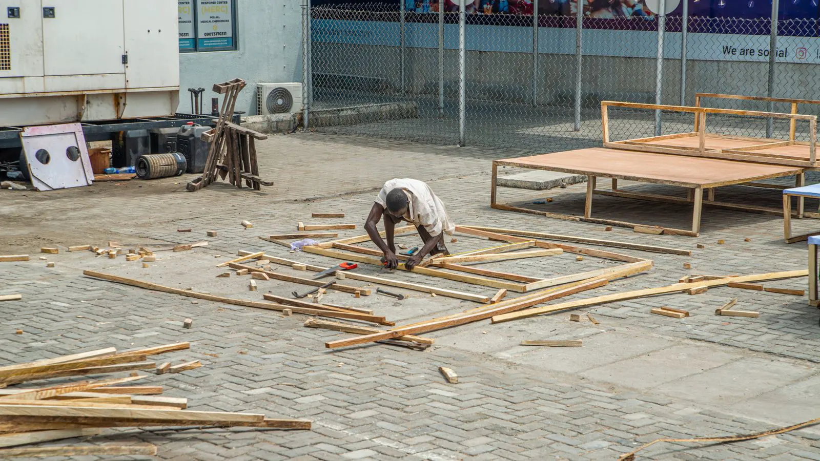 A carpenter checks the vertical alignment of a door frame with a level.