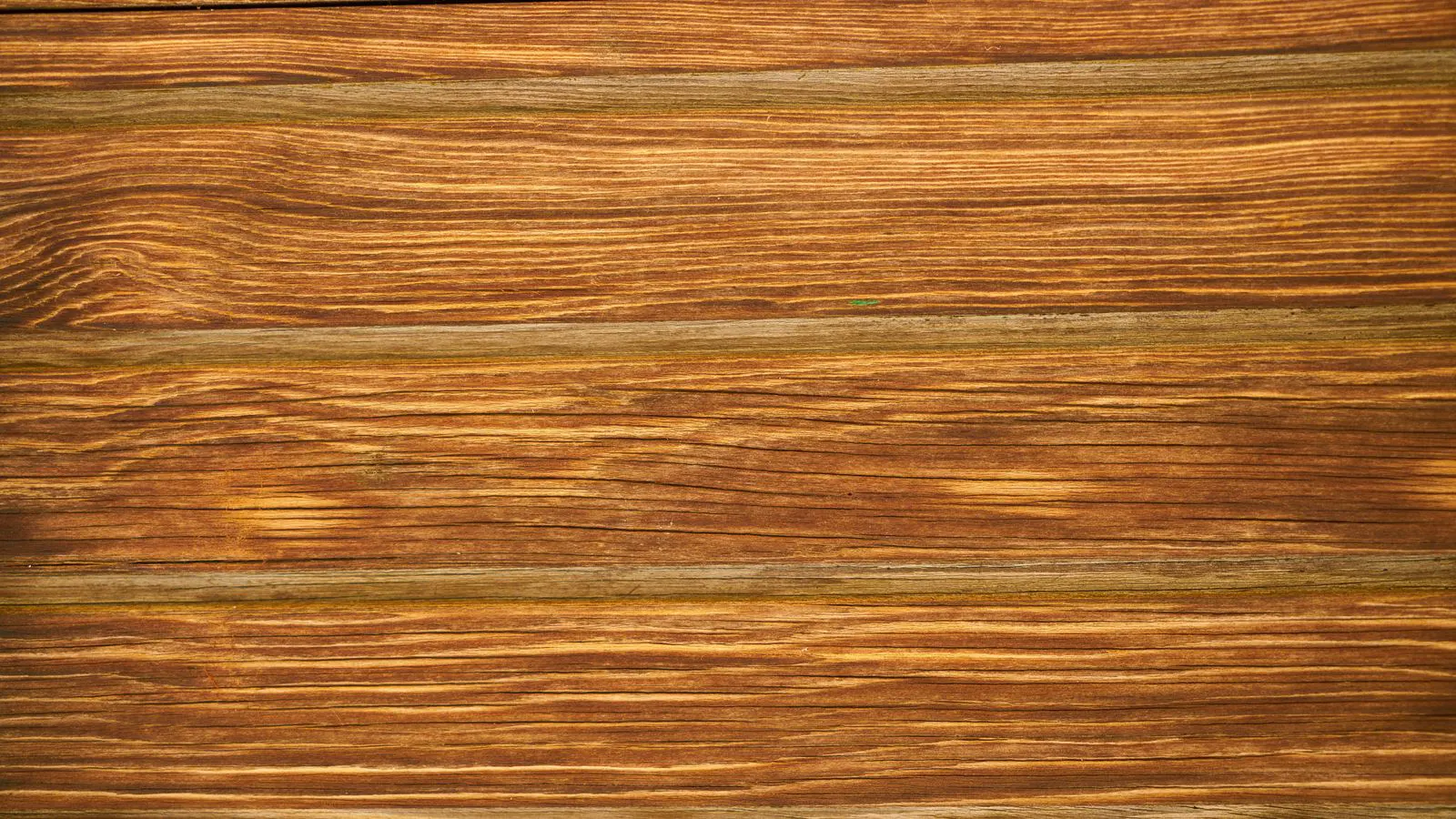 Cross-section of laminate plank showing wear layer, core, and backing