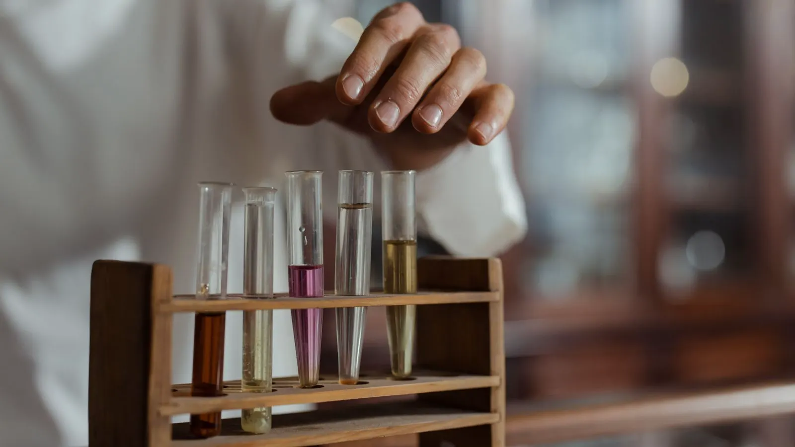 Lab technician rubbing a tab against laminate sample