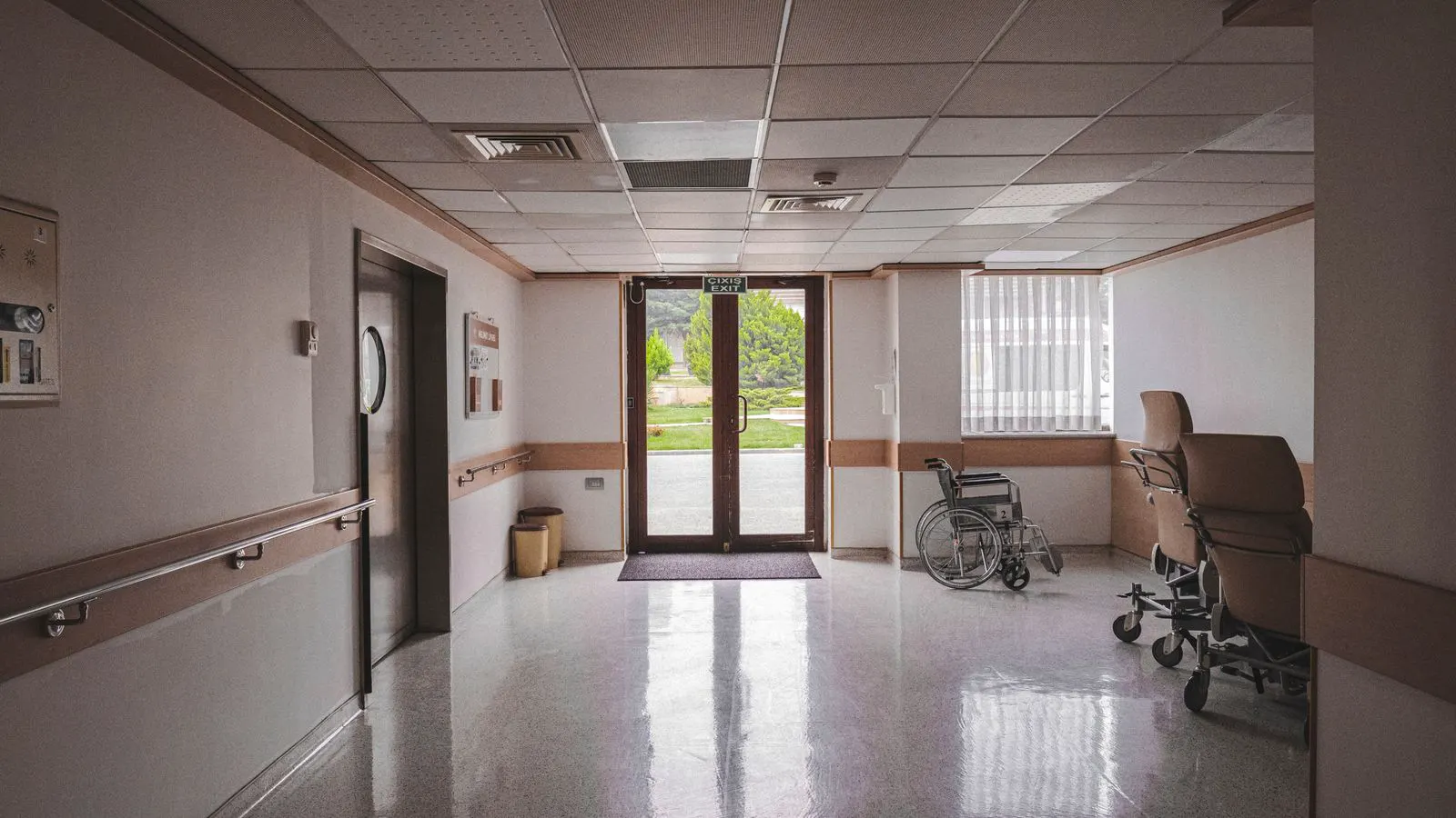 Clean white hospital corridor floor with soft lighting and no visible wear.