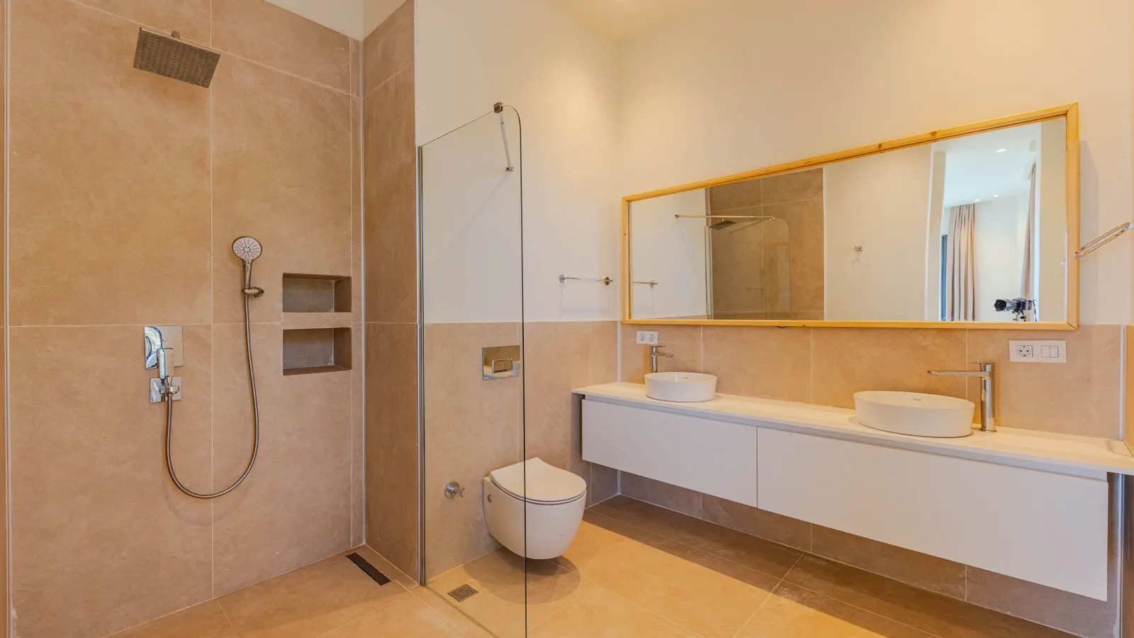 Large square porcelain tiles laid on a prepared concrete floor