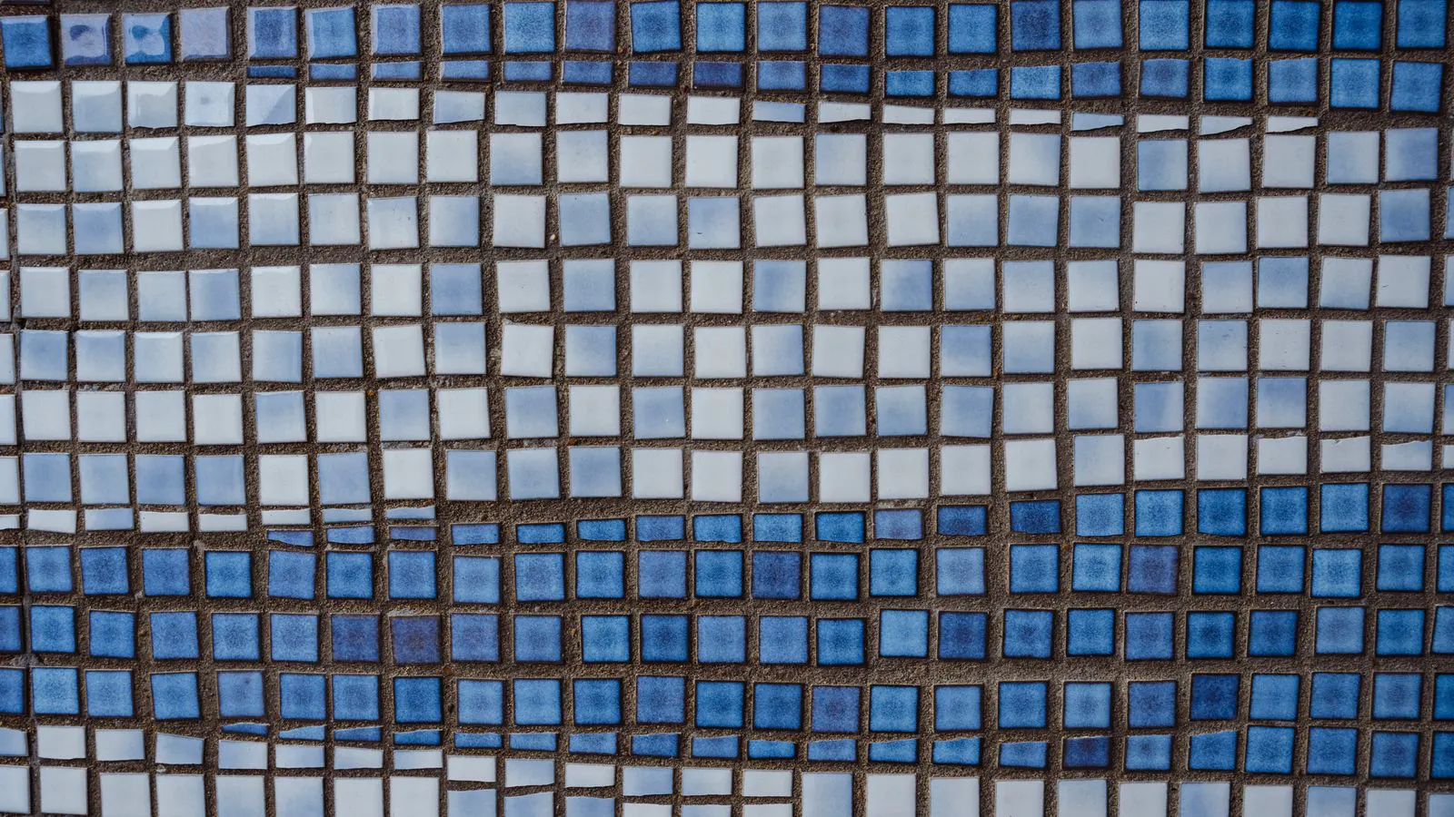 A wooden pallet with broken ceramic tiles and cardboard wrapping