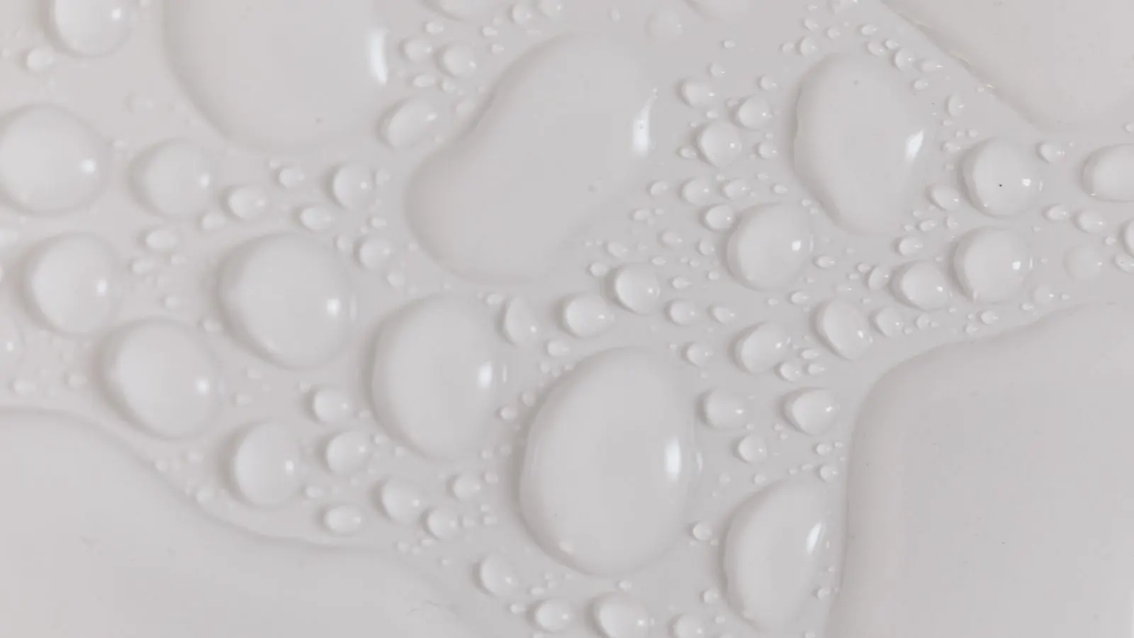 A close-up view of a tile cross-section with a water droplet on the surface