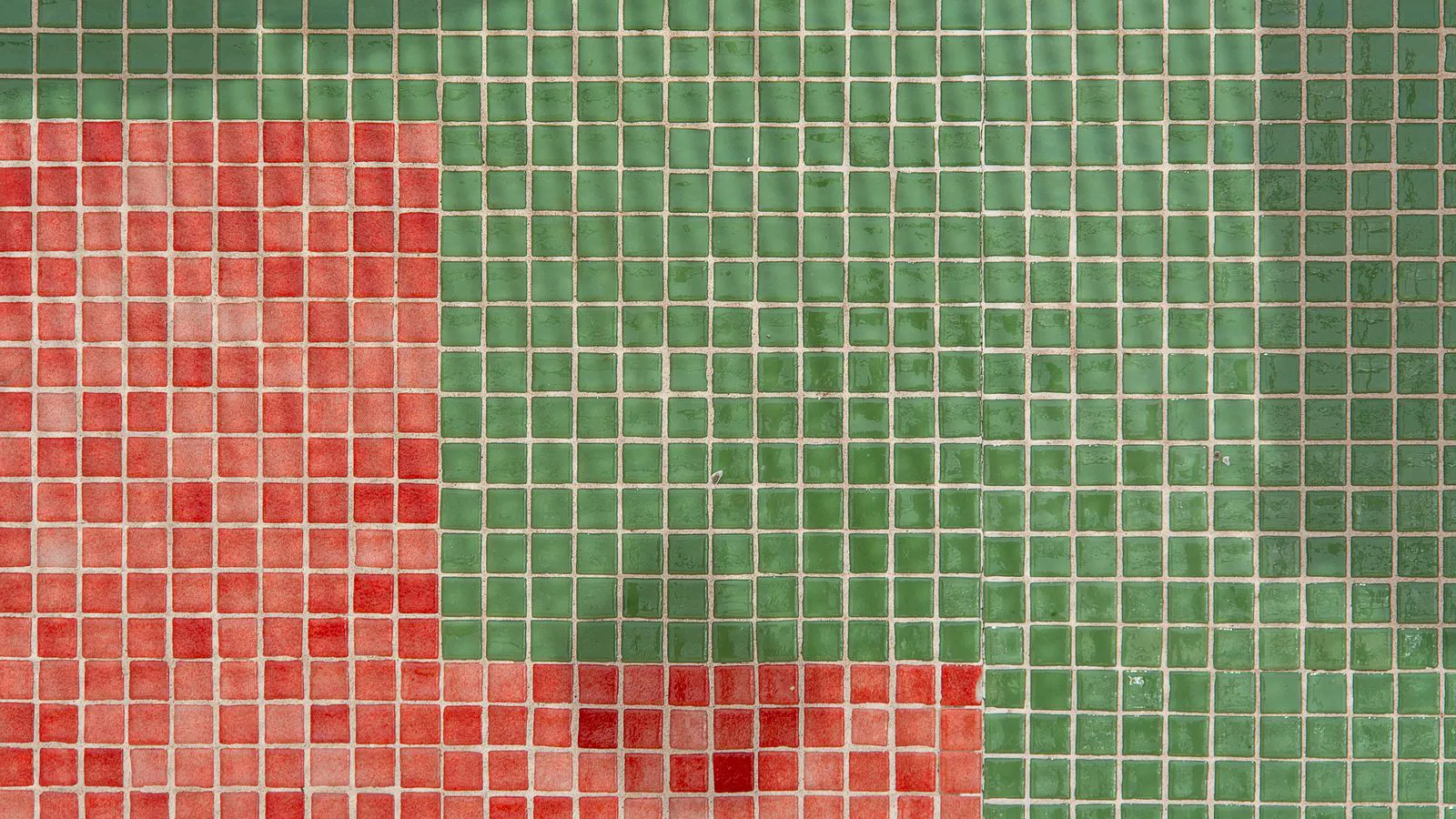 A close view of ceramic tiles showing edge irregularities and surface stains