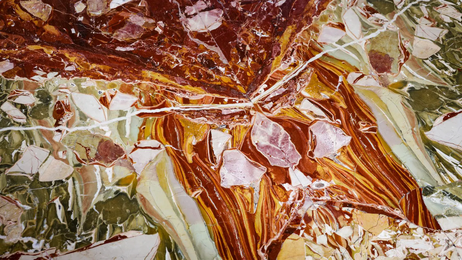 A large polished stone slab on an industrial processing table