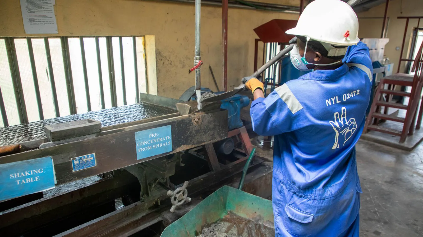 A natural stone slab undergoing finishing in a factory setting