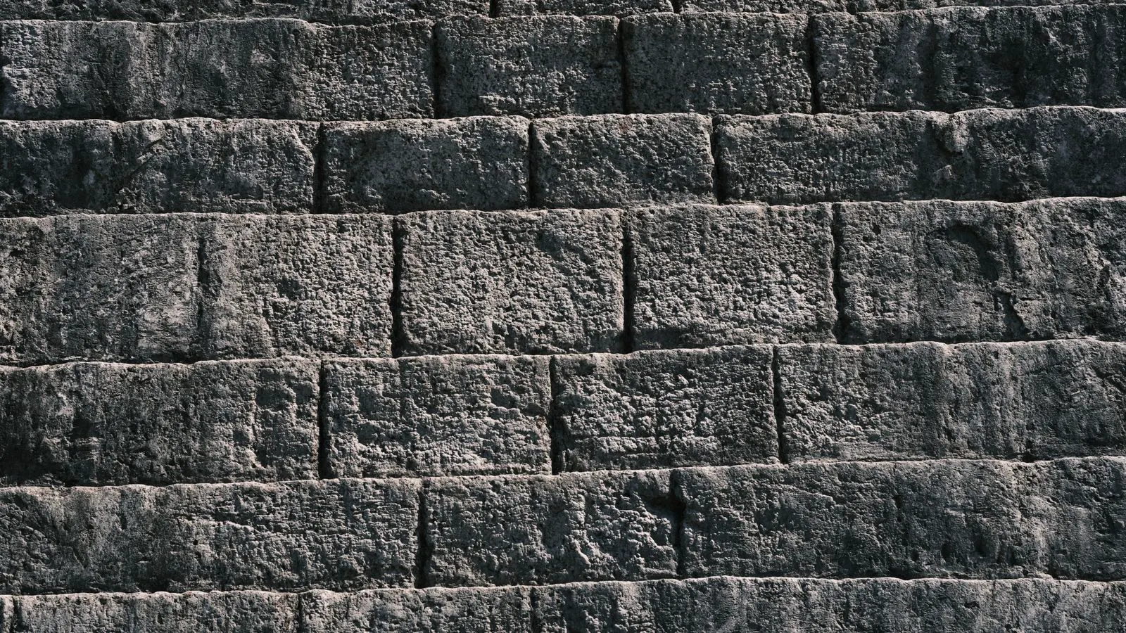 A weathered limestone wall facing a coastal horizon