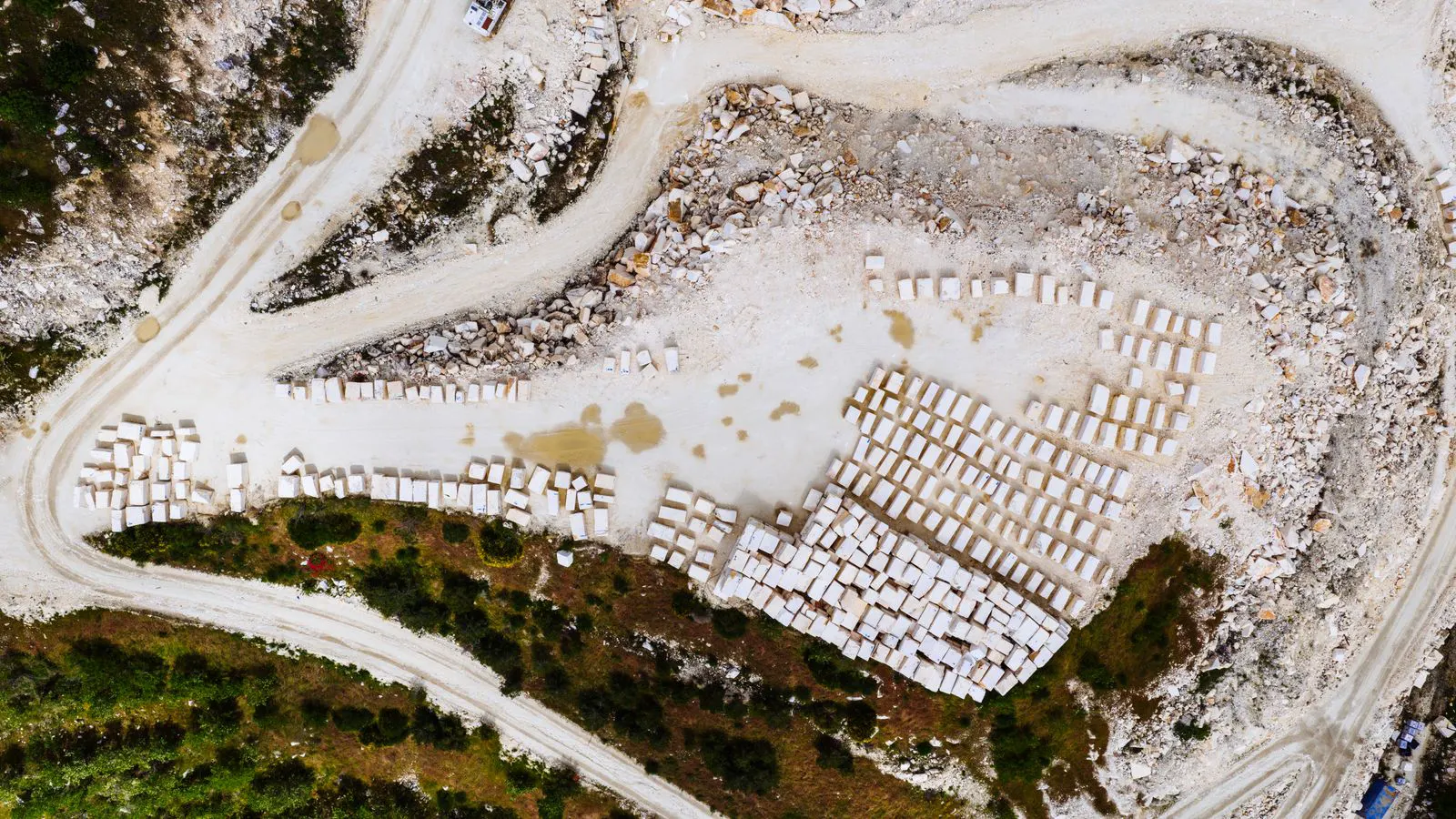Large blocks of natural stone being cut in a quarry.