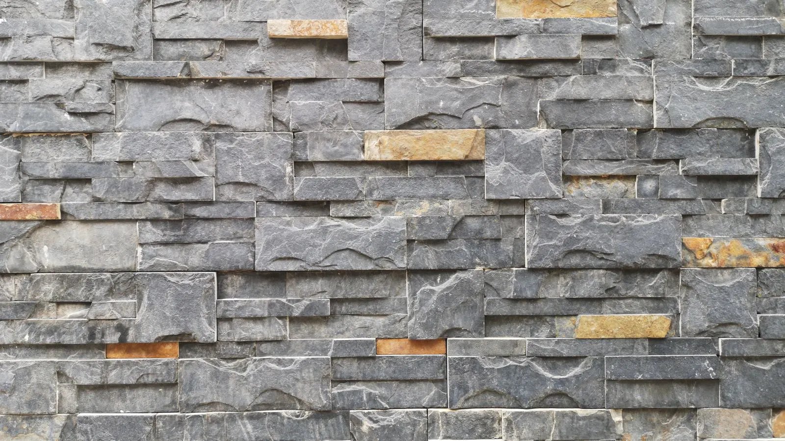 Two stone slabs showing distinct grain patterns on a building exterior.
