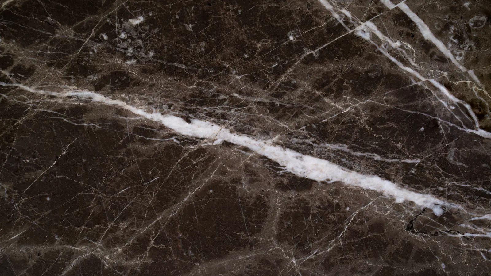 Close view of a polished stone slab next to a honed stone slab.