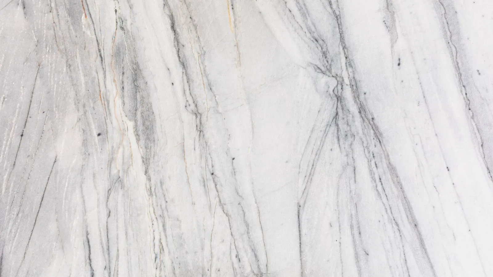 A split view showing white marble and gray granite countertop surfaces.