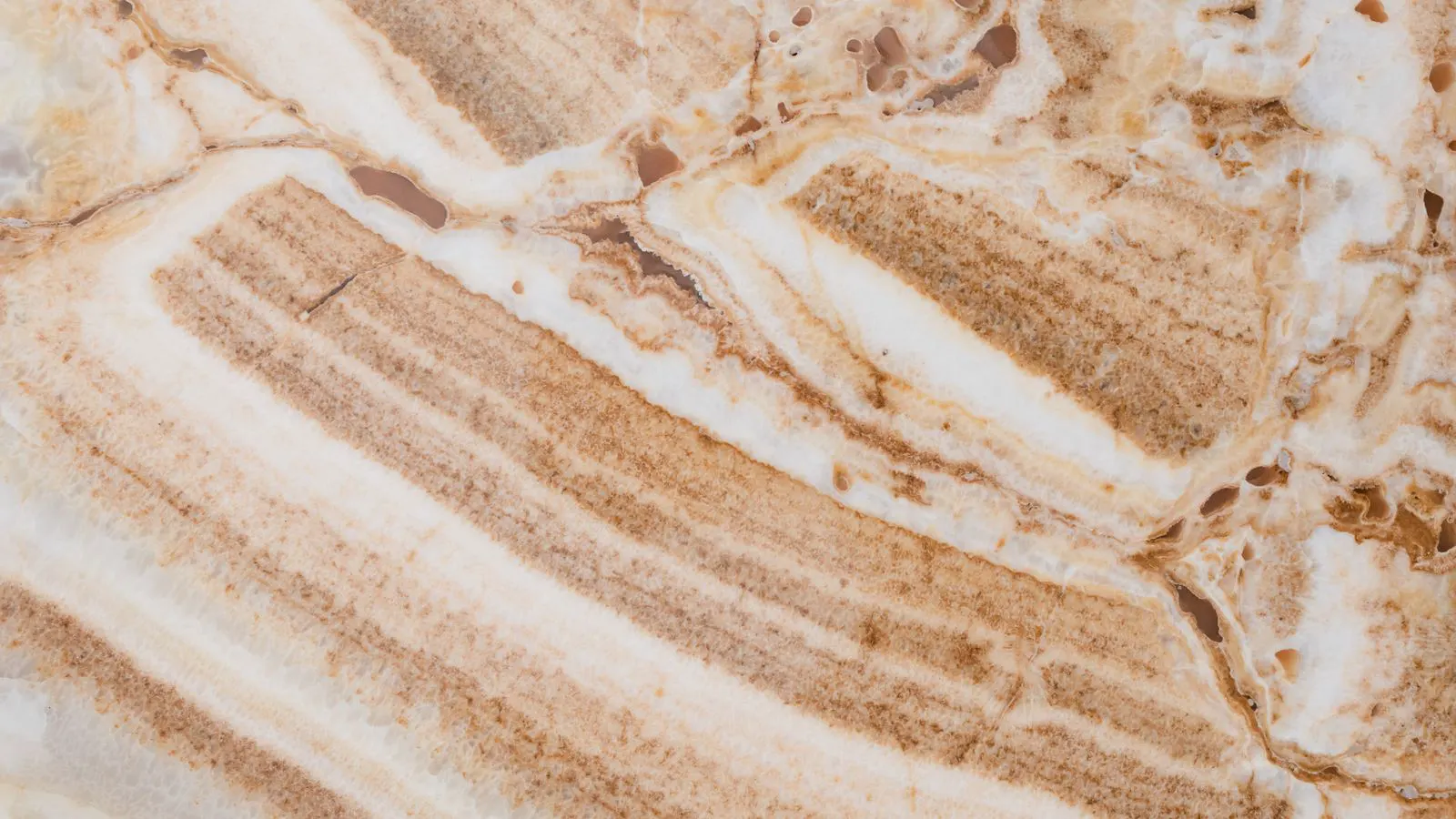 Large polished quartzite slabs stacked in a stone warehouse