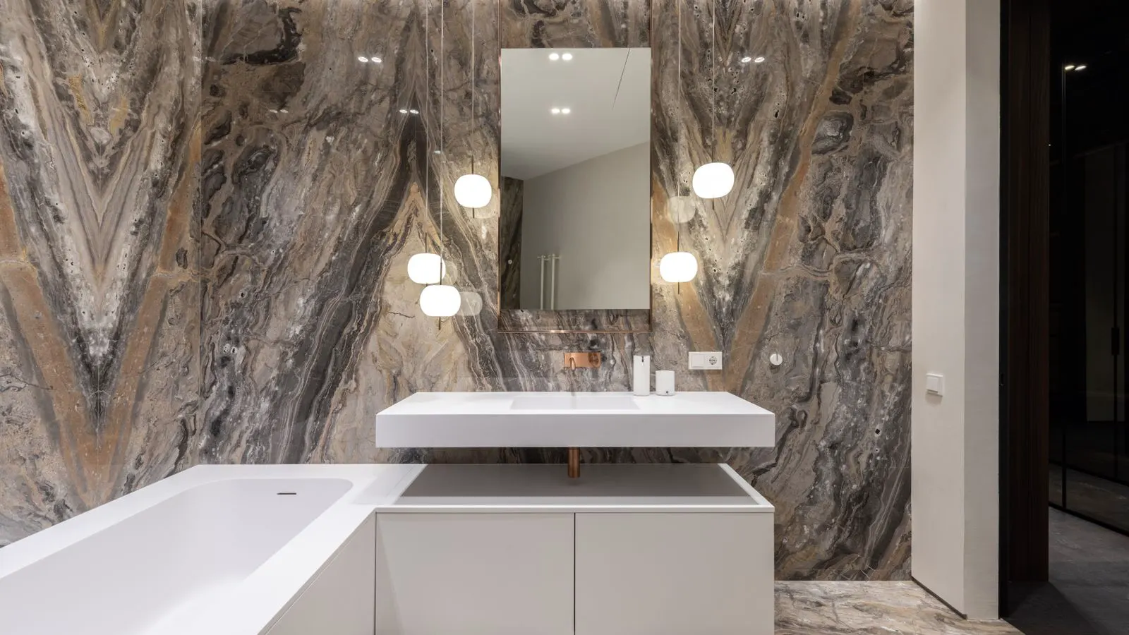 A desk with technical drawings, certificates, and a chrome faucet.