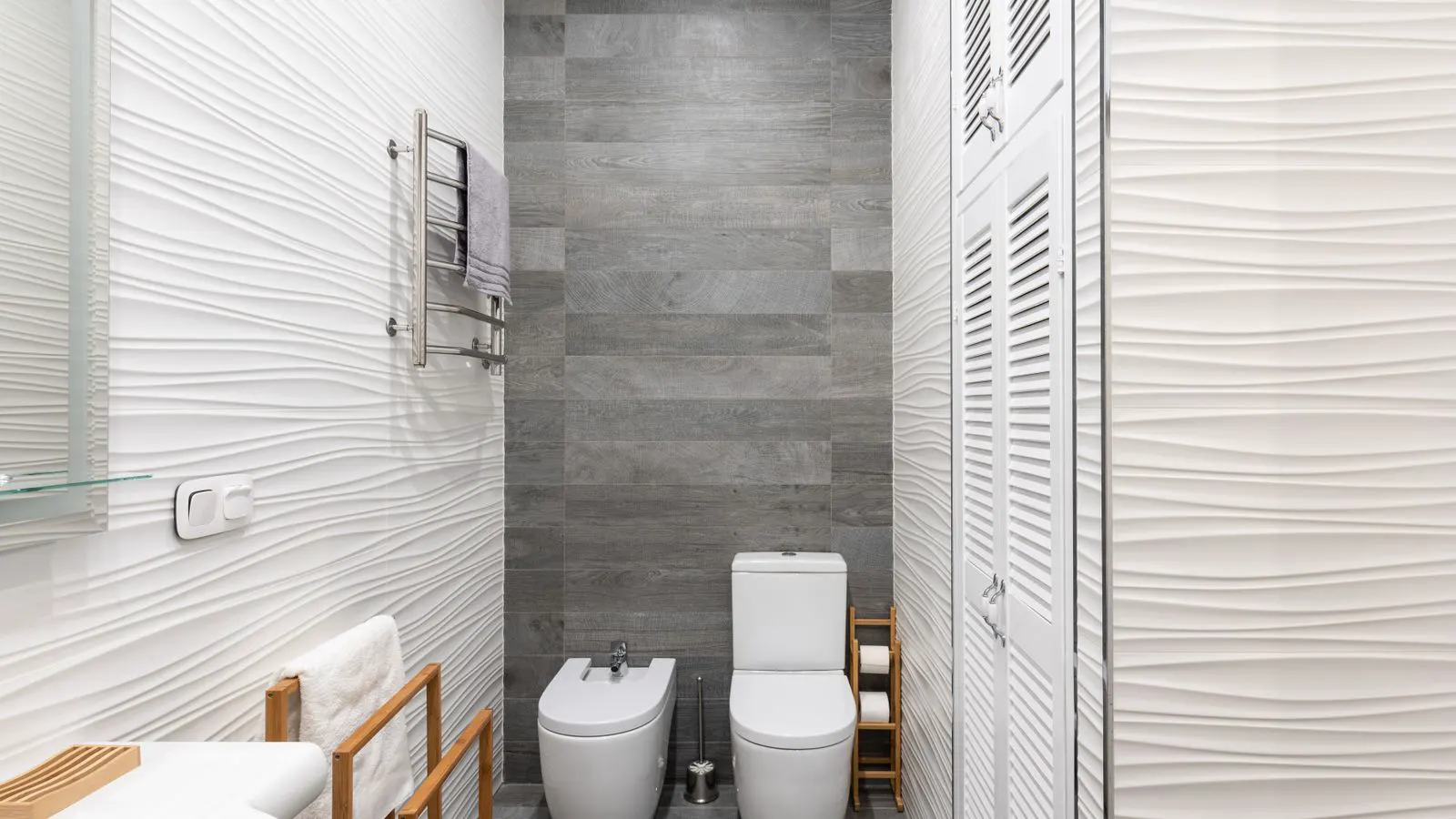 Technical drawings and compliance documents for bathroom fittings on a desk