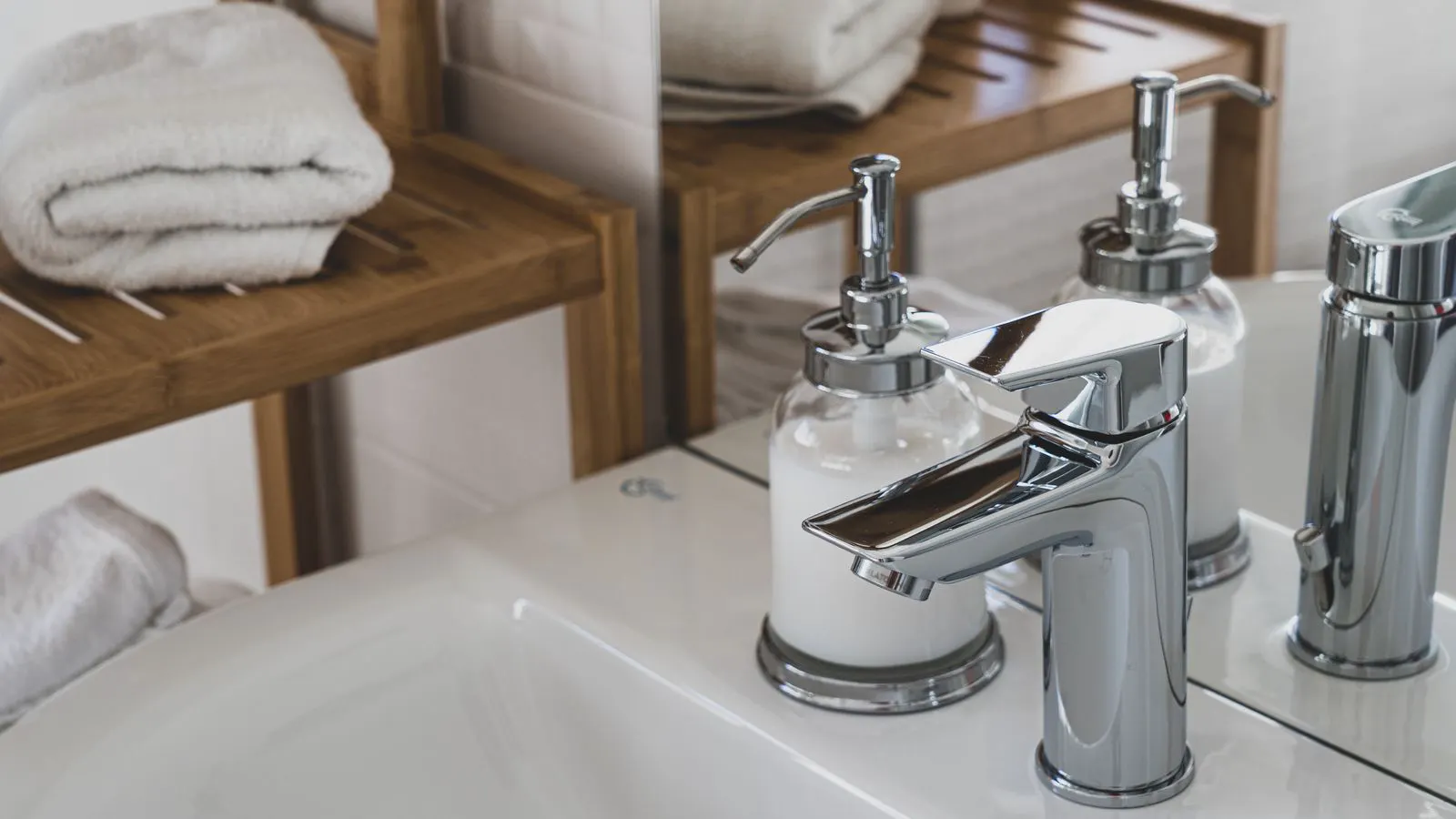 Close view of a polished chrome bathroom faucet showing mirror finish
