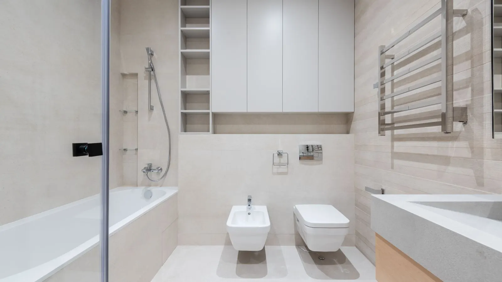 Stacked ceramic basins and chrome faucets on wooden shelves
