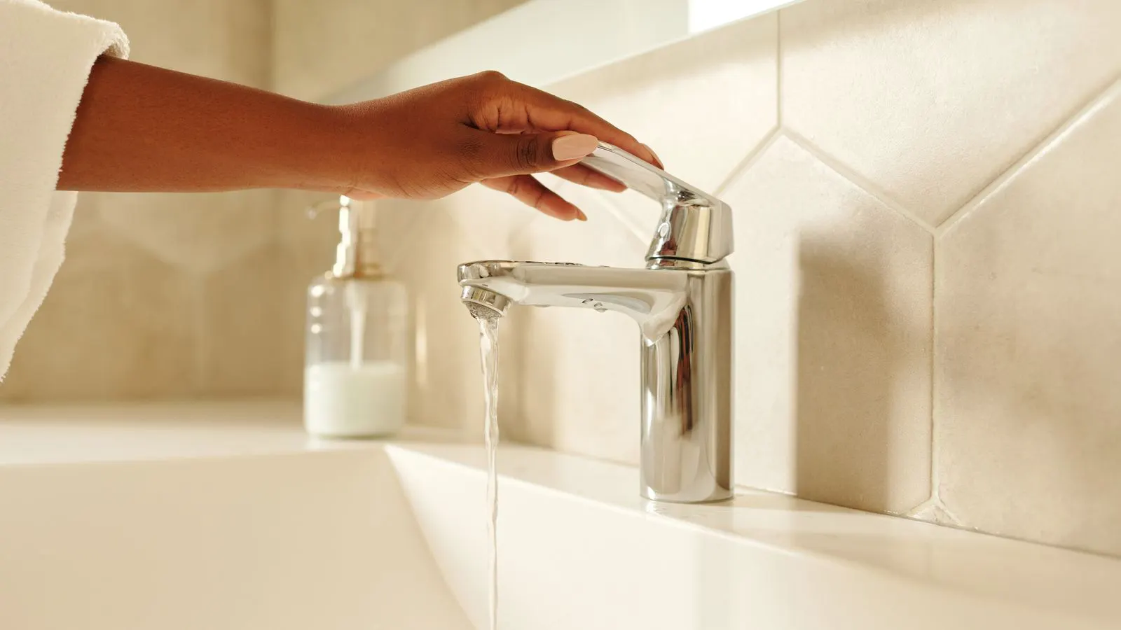 Close up of a bathroom mixer and showerhead with certification markings