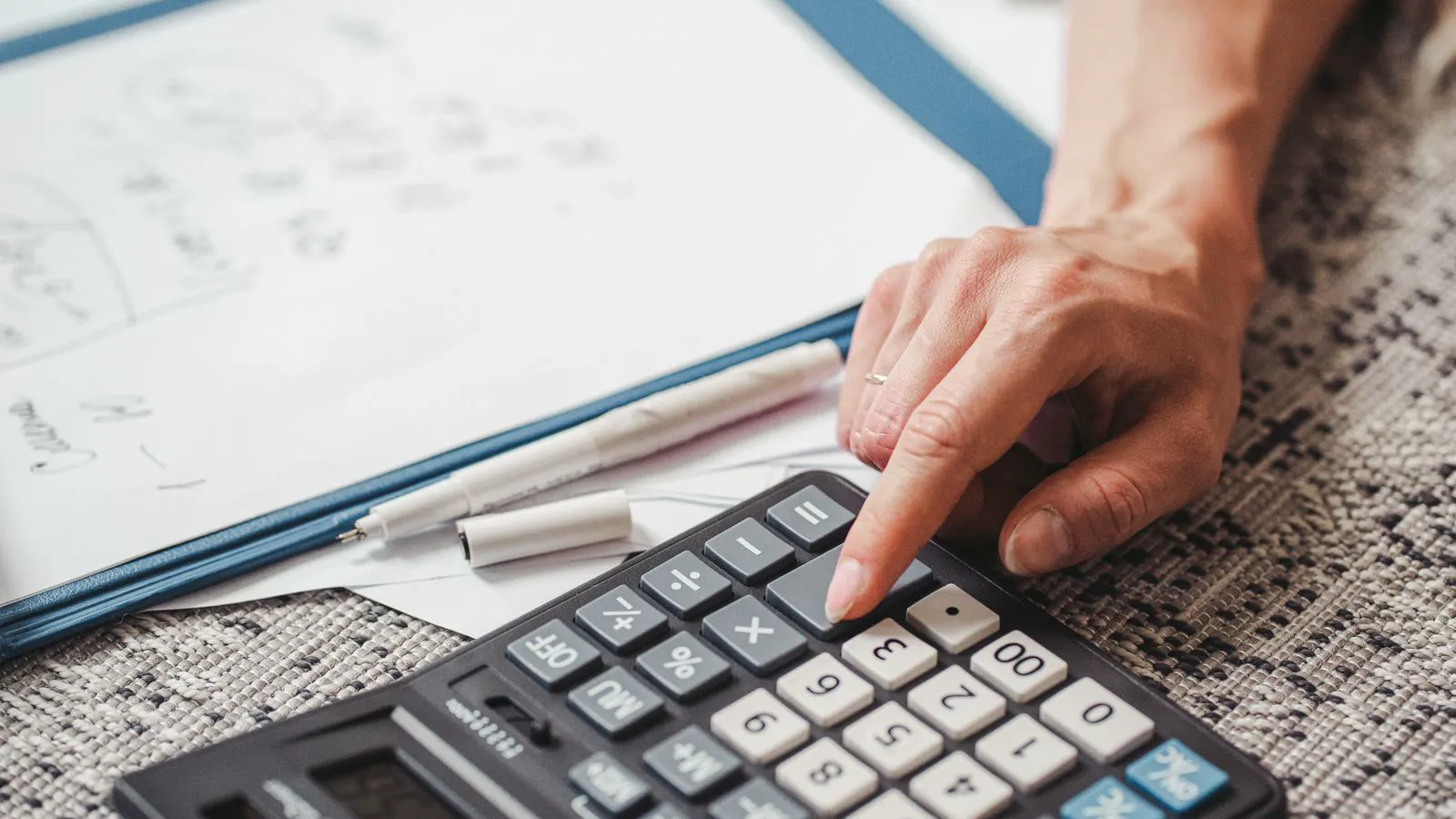An engineer reviews thermal load analysis results at a drafting table.