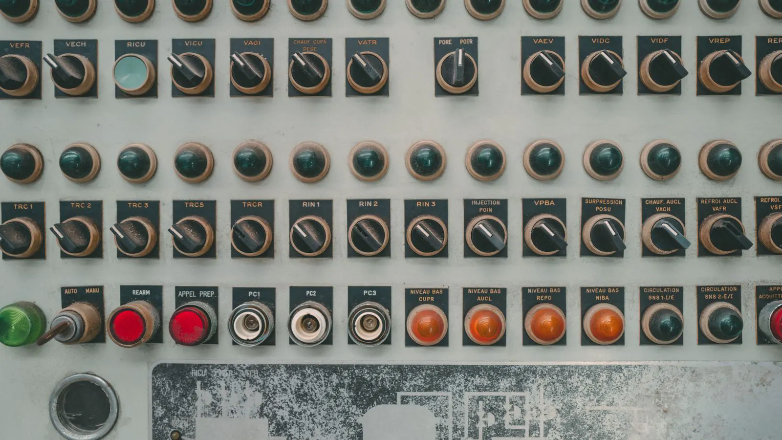 A technician checks a digital control panel on a large industrial chiller.