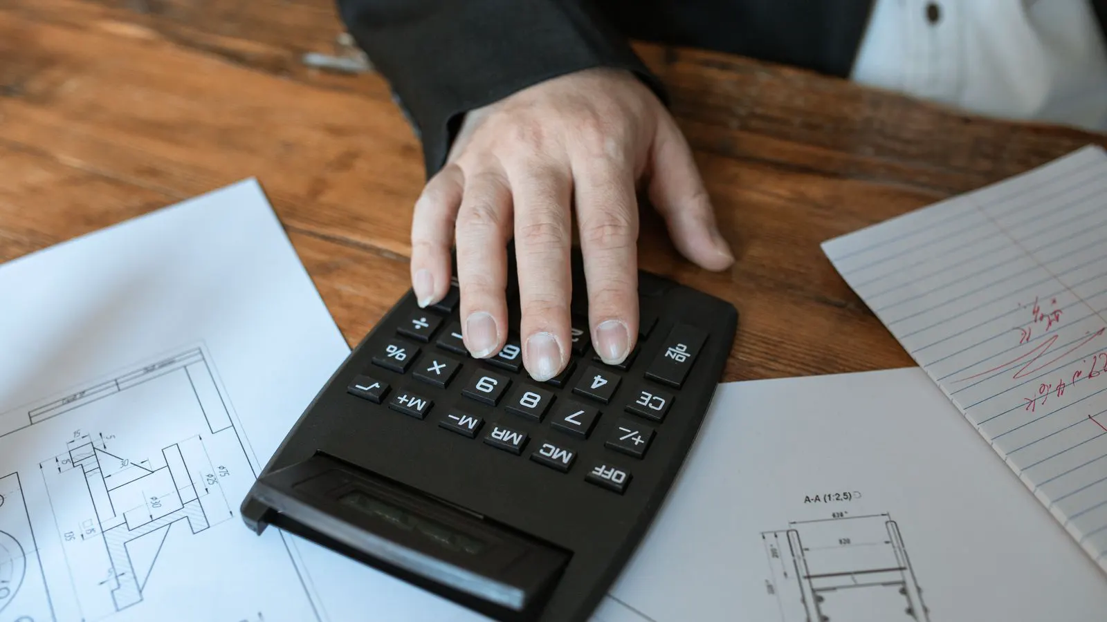 Engineer reviewing cooling load calculations on a clipboard.