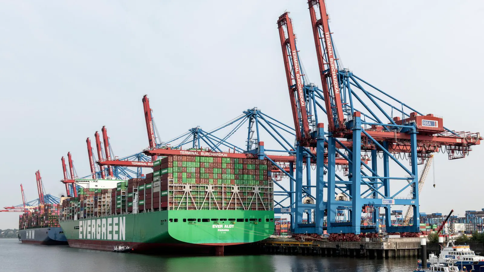 Steel pipes moving into a secure container at a port