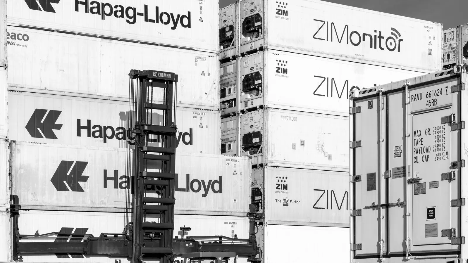 A stack of steel pipes inside an open shipping container