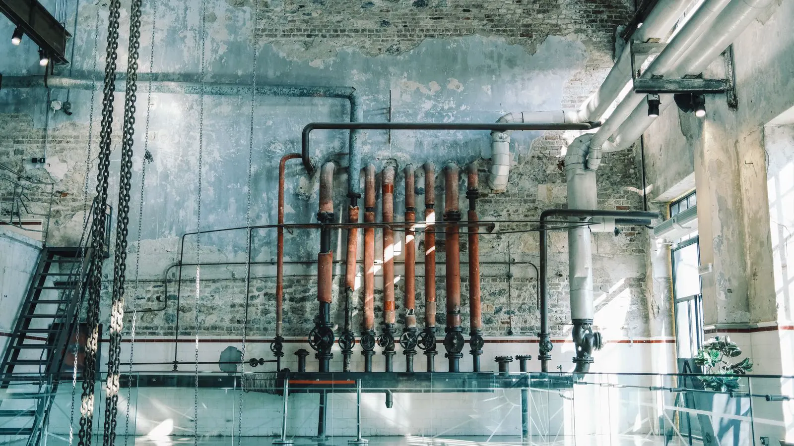 Coiled carbon steel and stainless pipe stacked in warehouse racks