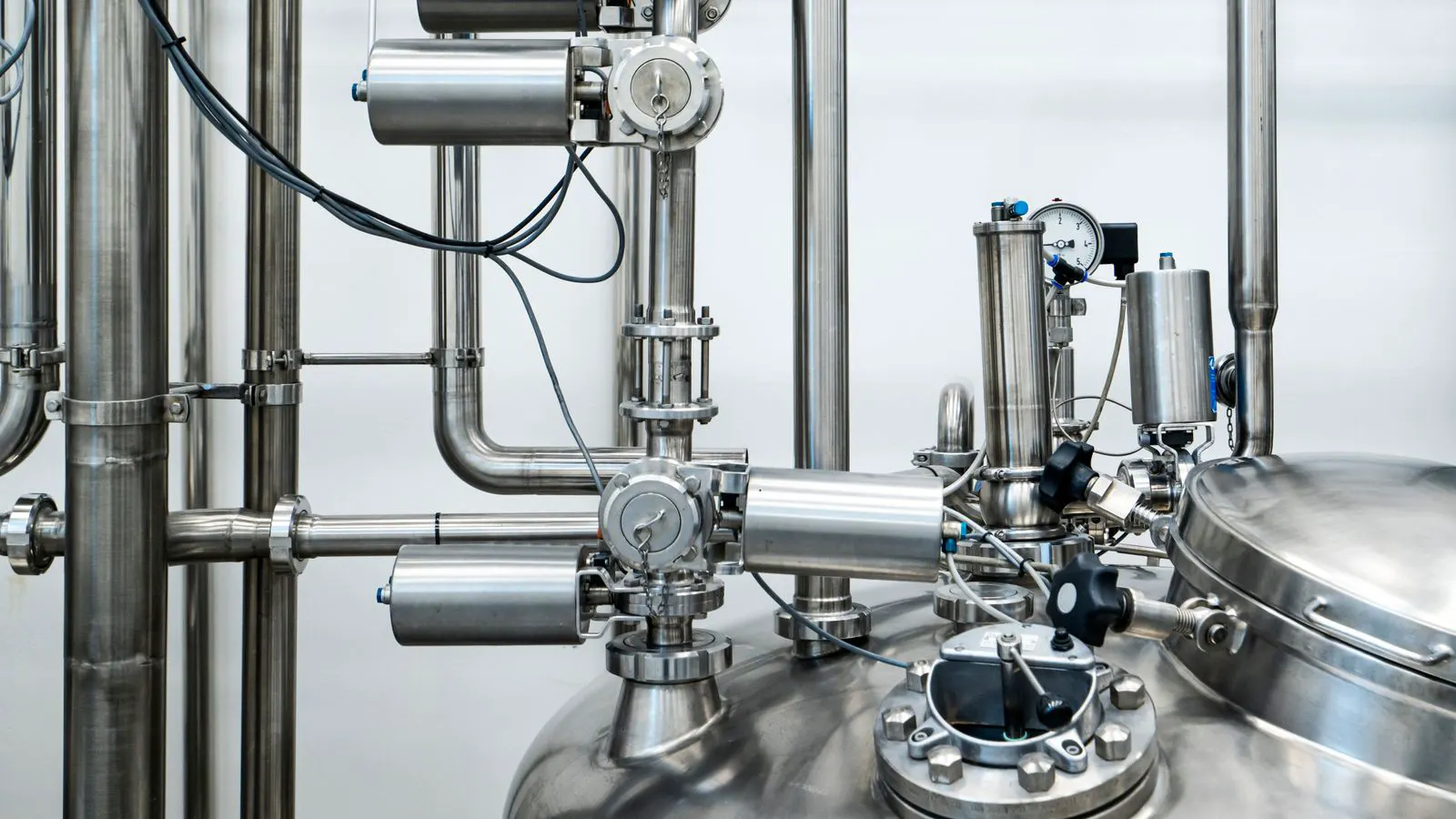 Close-up of polished stainless steel flange with bolts