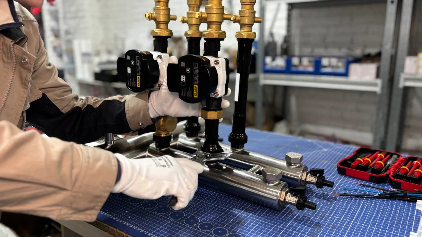 A technician checking a ball valve on a pipe