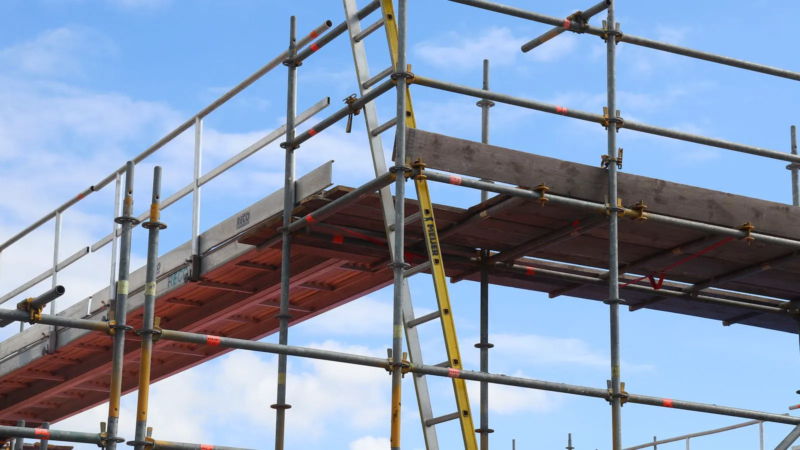 Steel frame formwork panels set against a concrete wall
