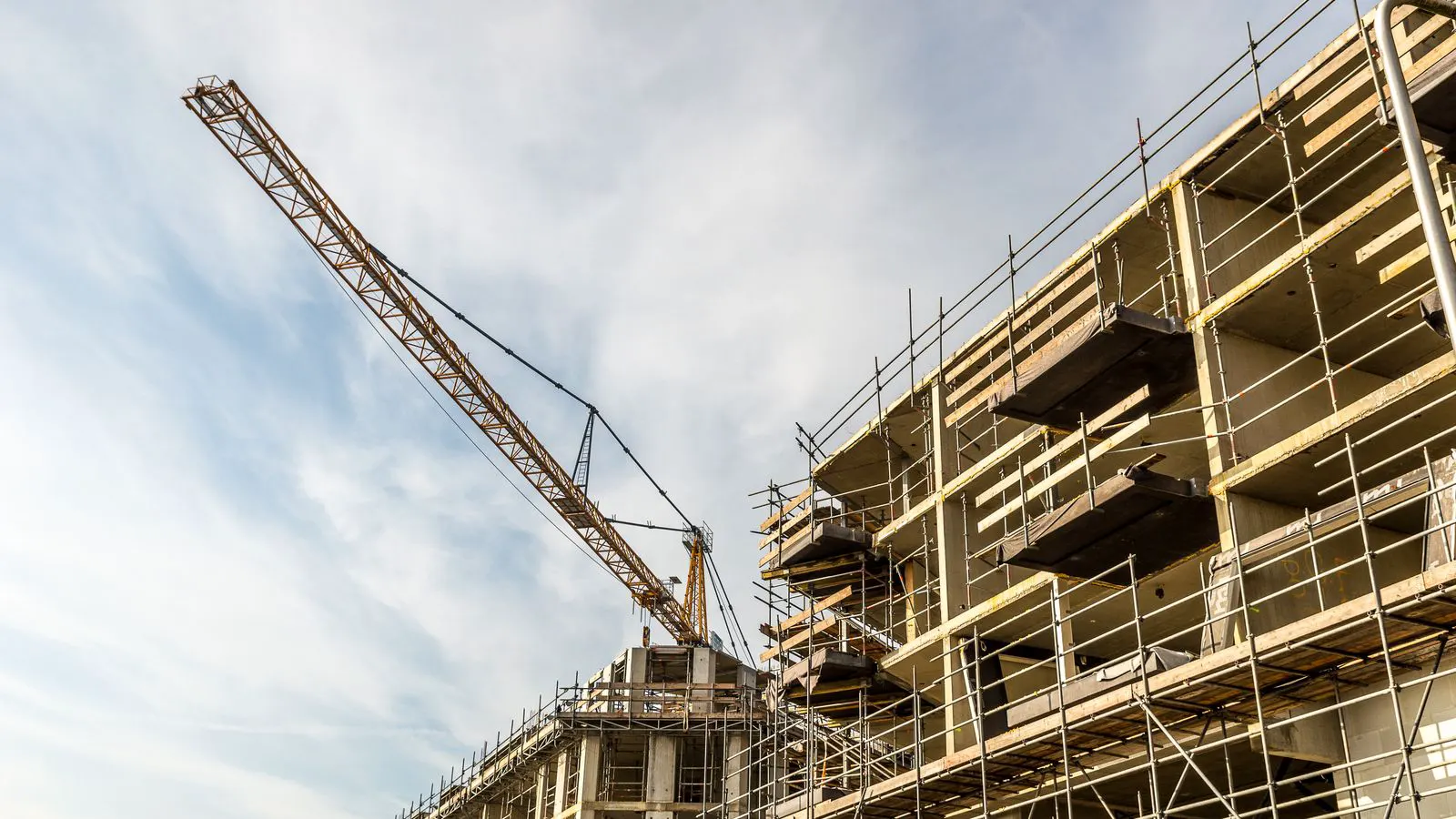 Steel scaffolding frames standing on a concrete site