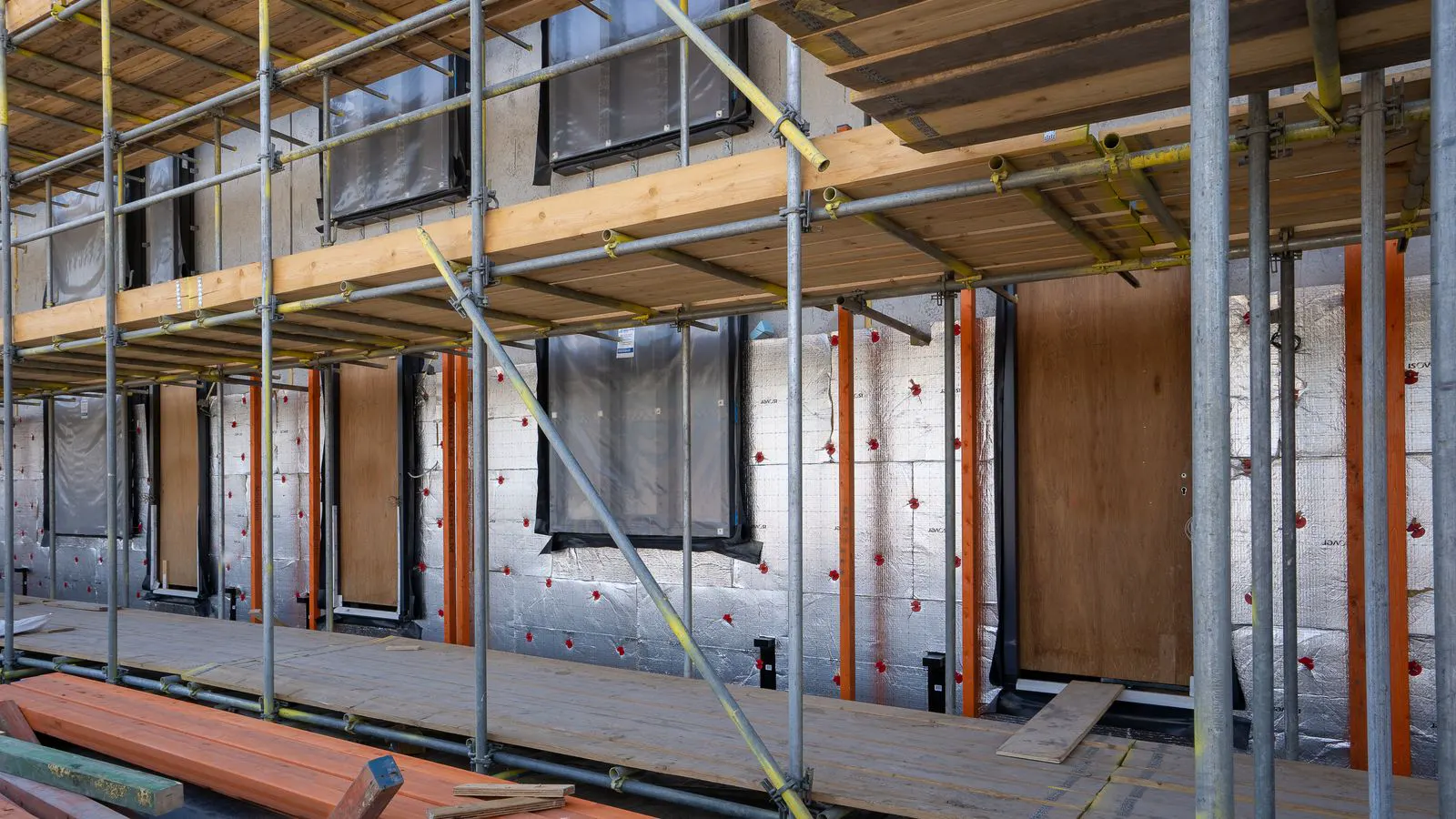 Stacked aluminum formwork panels on a construction site