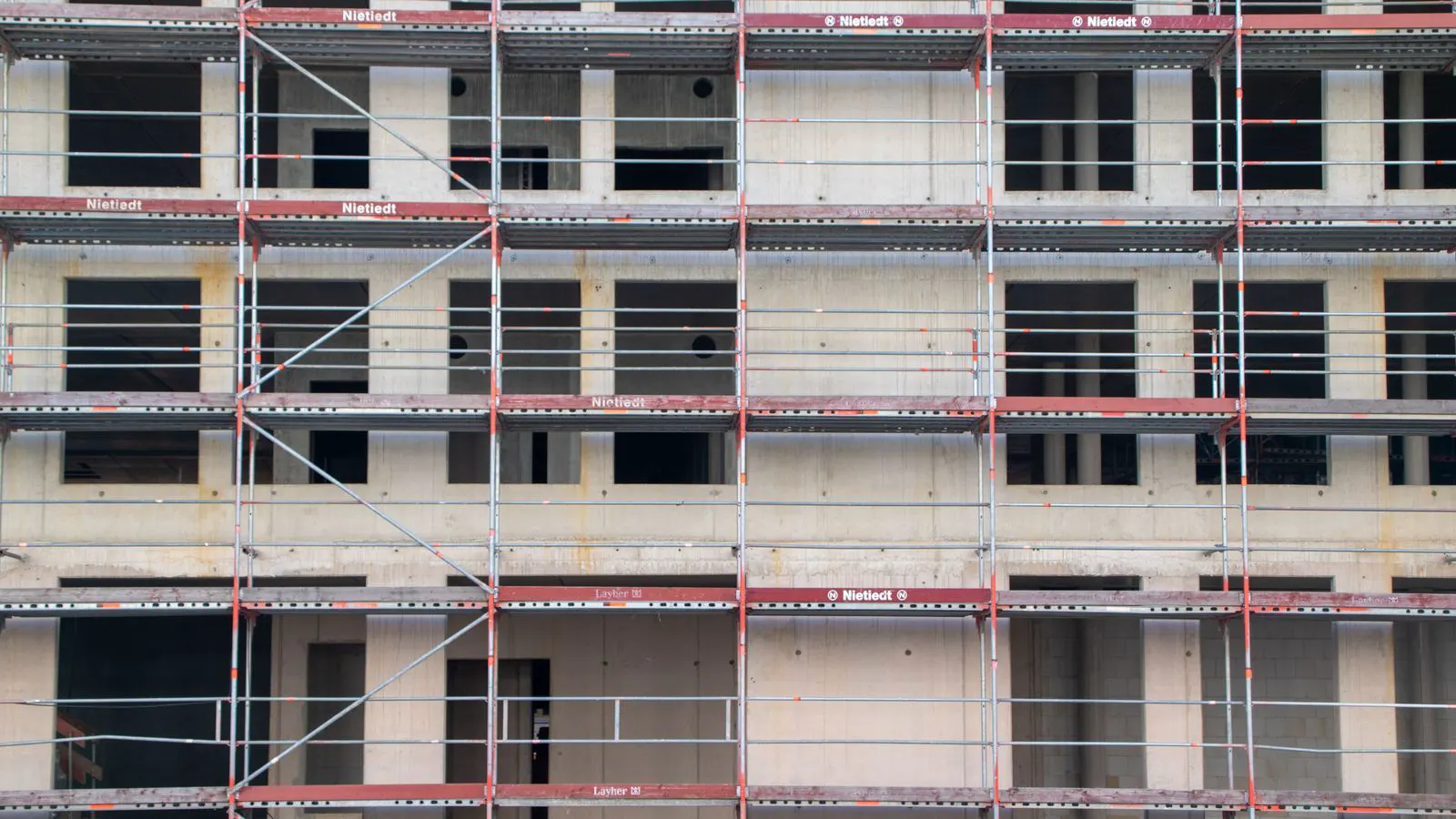 A steel scaffold frame standing upright on a concrete pad