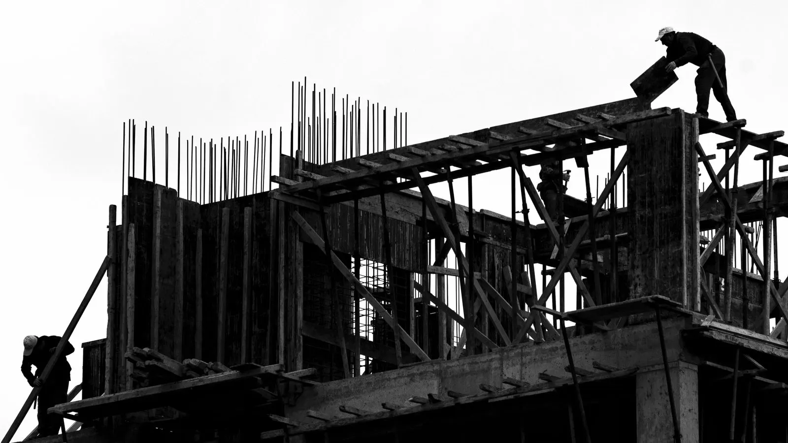Aluminum and timber formwork panels stacked side by side on a site.