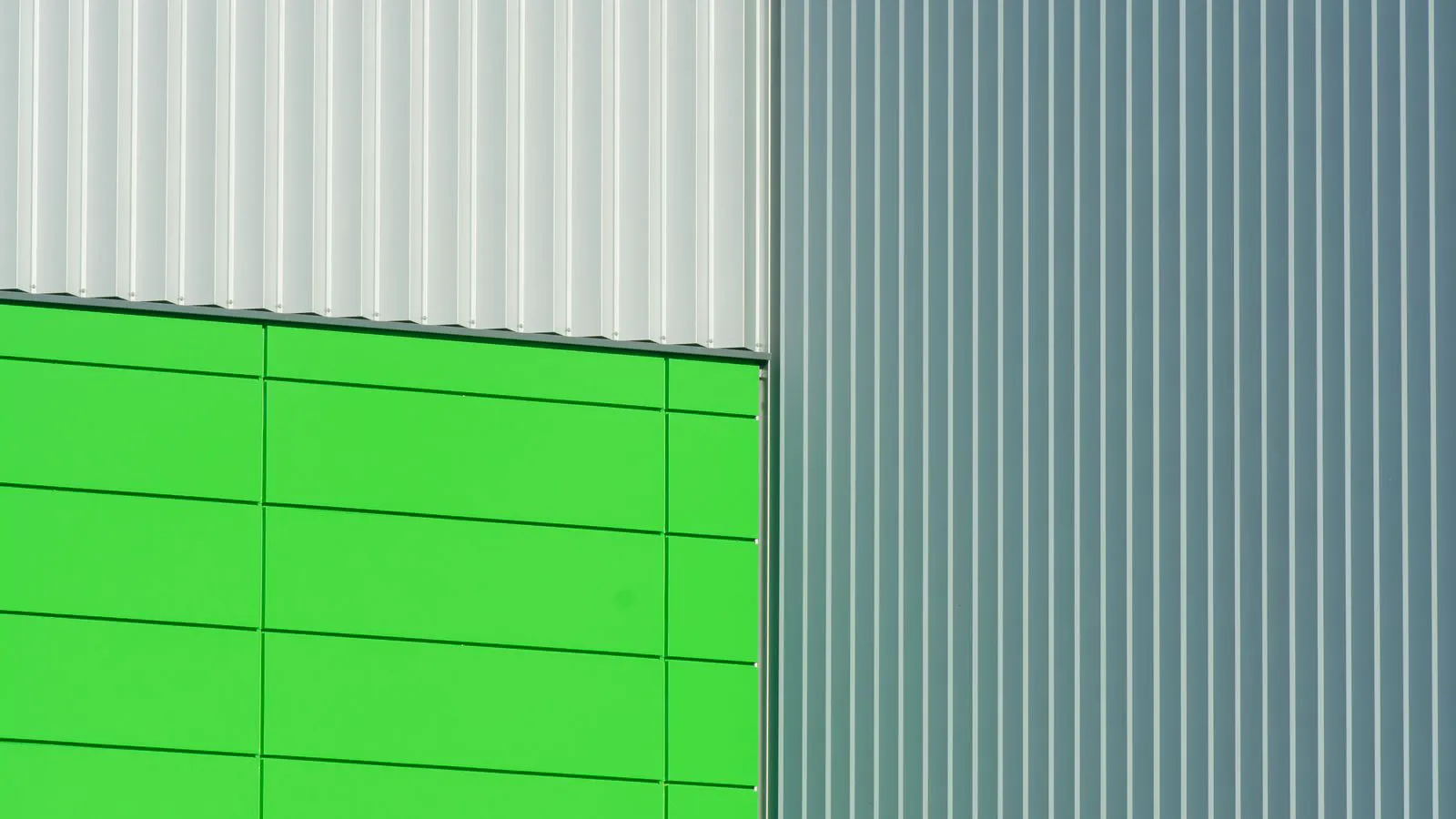 A vertical wall of aluminum formwork panels held by metal frames.