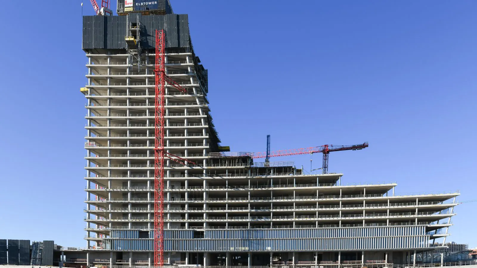 Stack of aluminum formwork panels beside a concrete column base