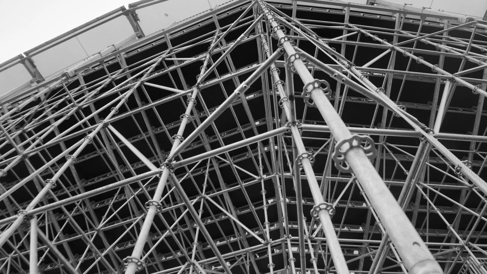 Close view of steel scaffold tubes and couplers on a construction floor
