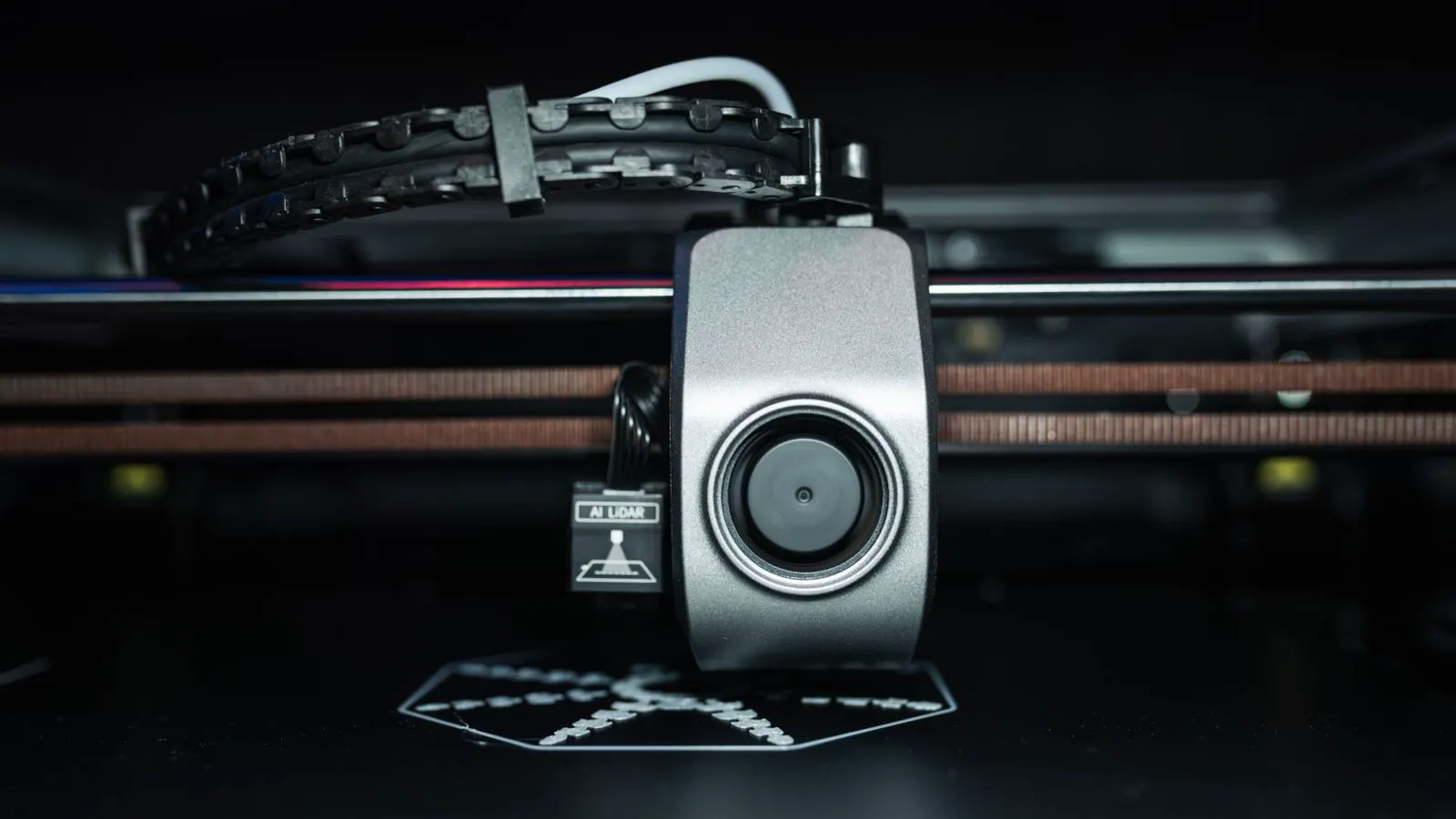 A digital printer head aligning over a roll of blank labels.