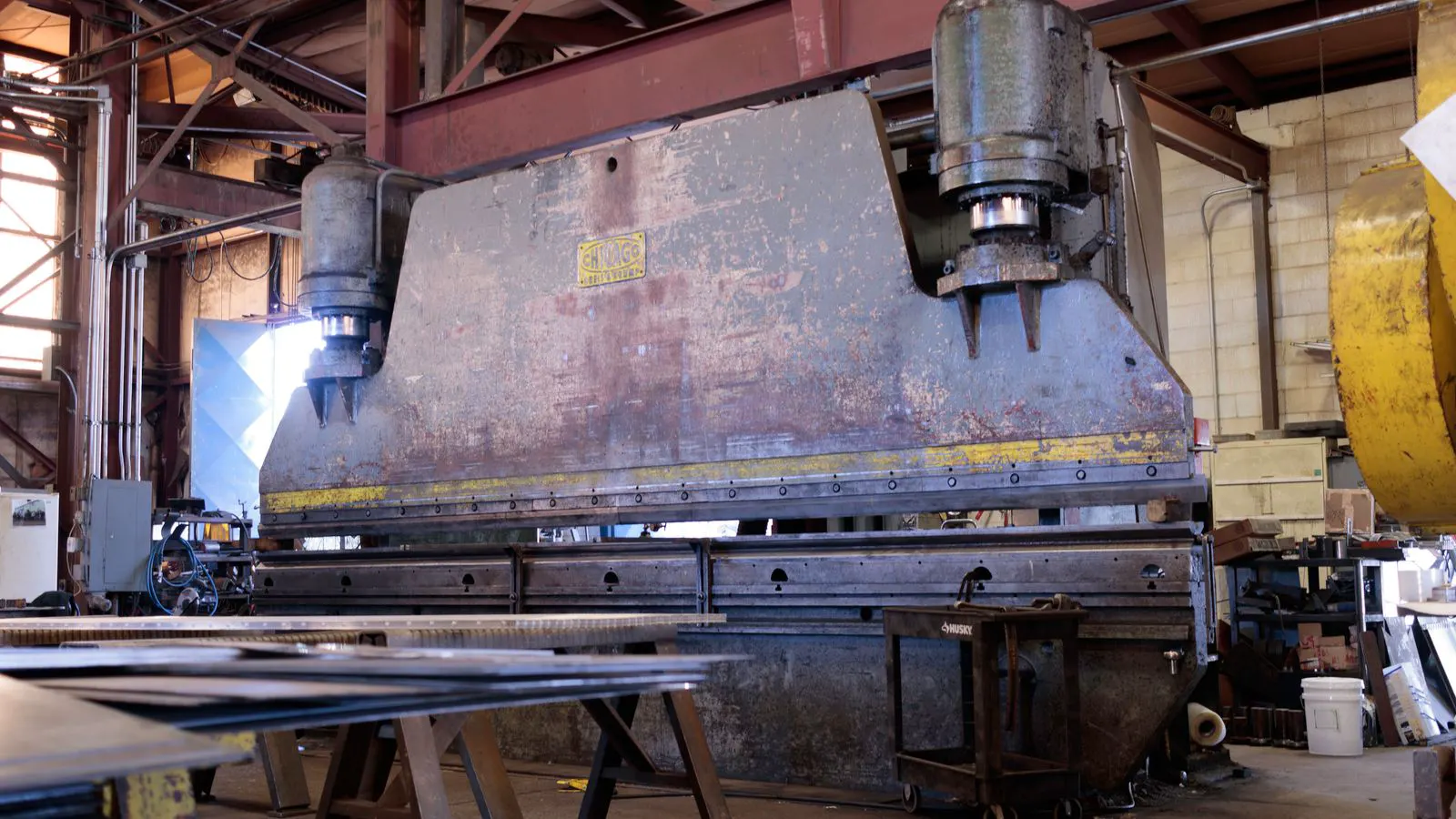 Printing presses handling rigid packaging materials in a production environment