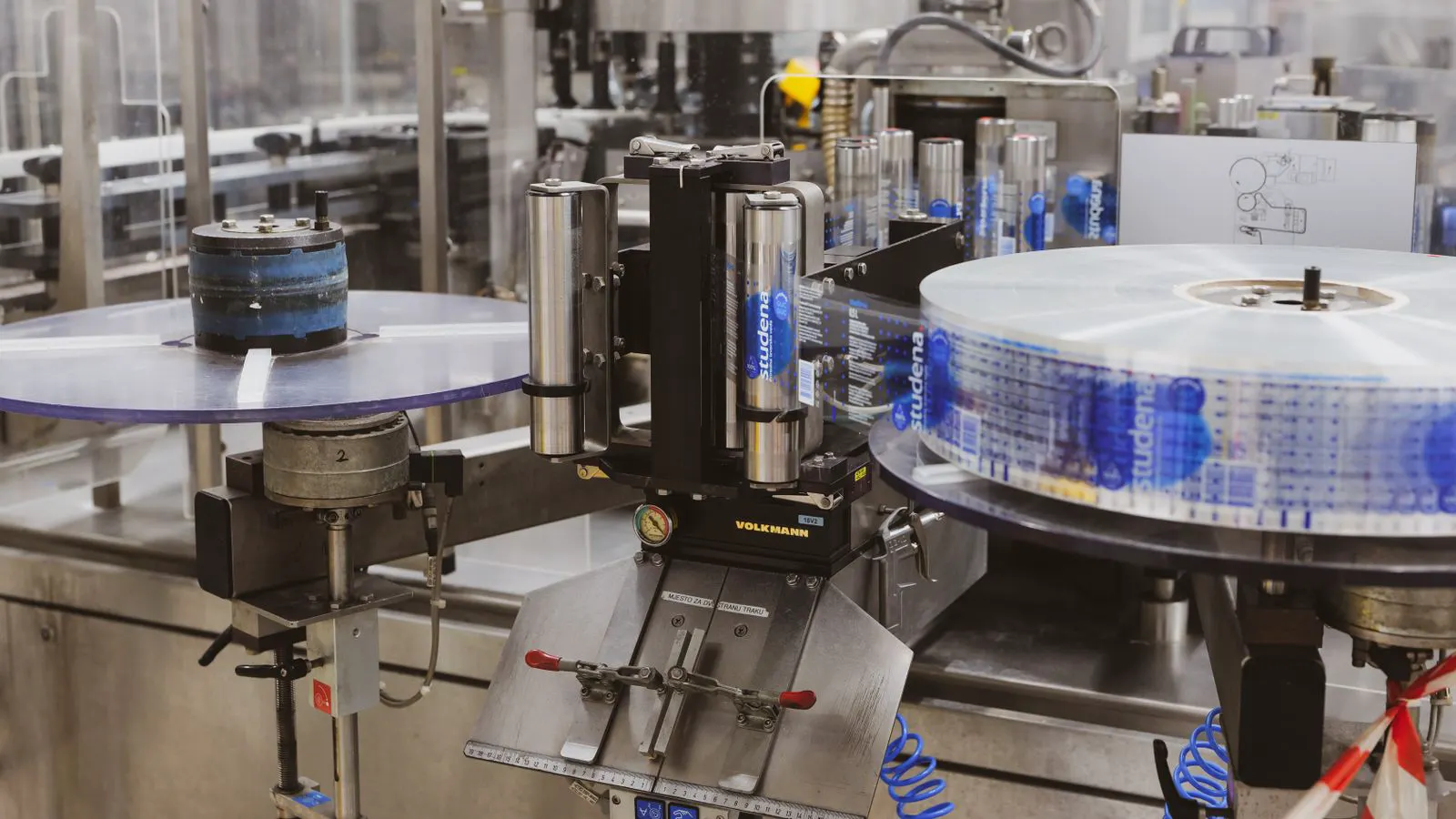 Close up view of printed labels being applied to glass jars