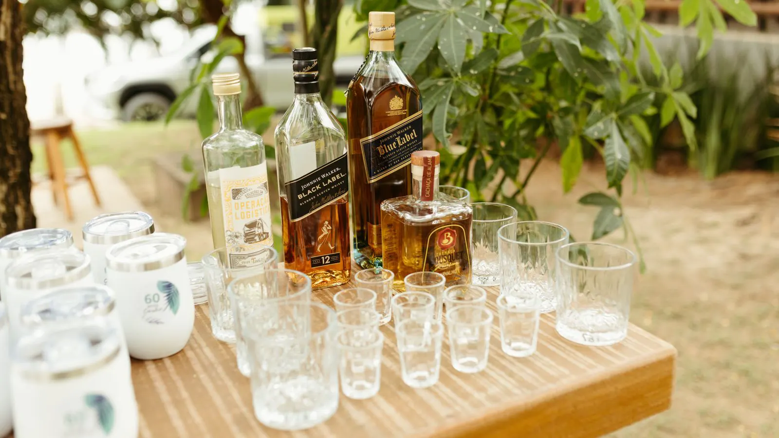 A row of glass bottles placed on a flat table for quality inspection.