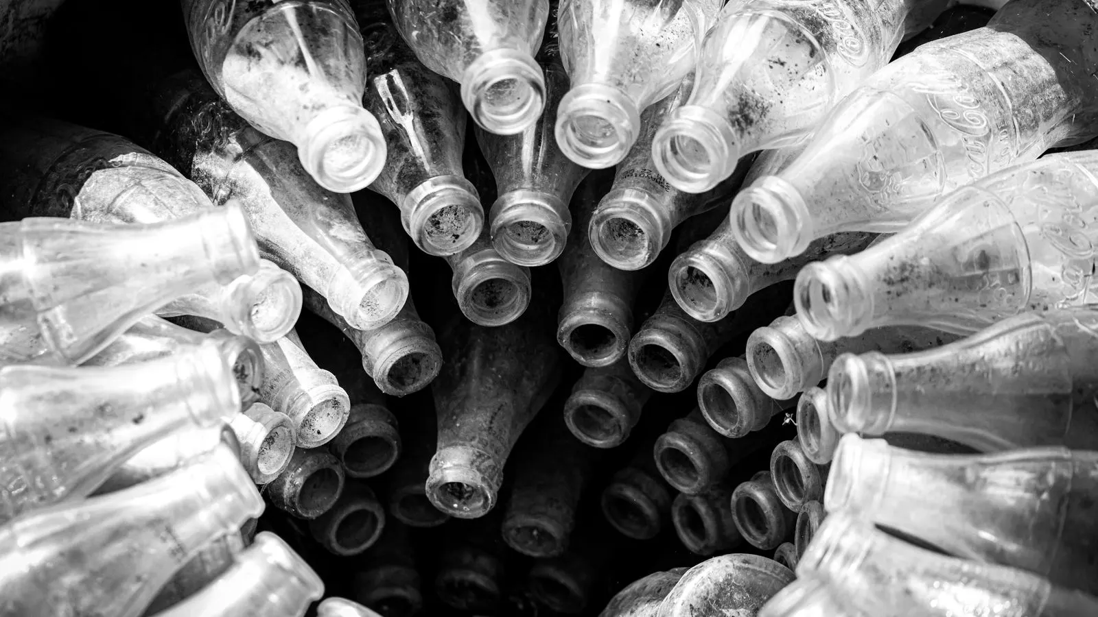 Close up of clear glass bottles on a production line.