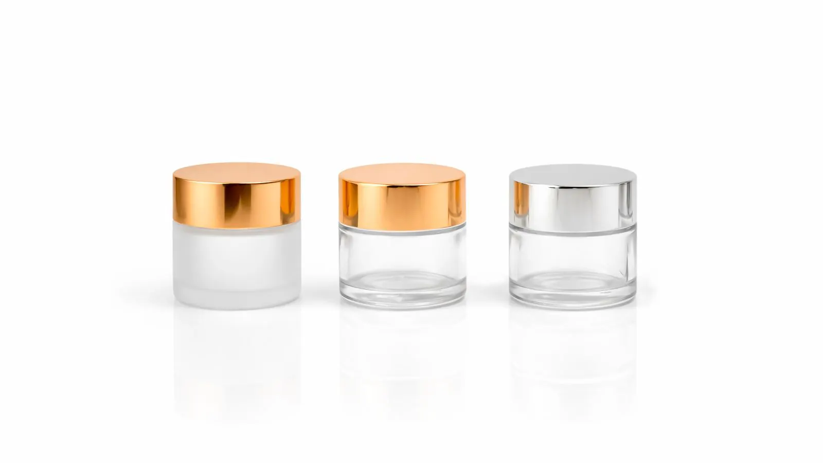 A row of glass jars with metal screw caps and paper labels