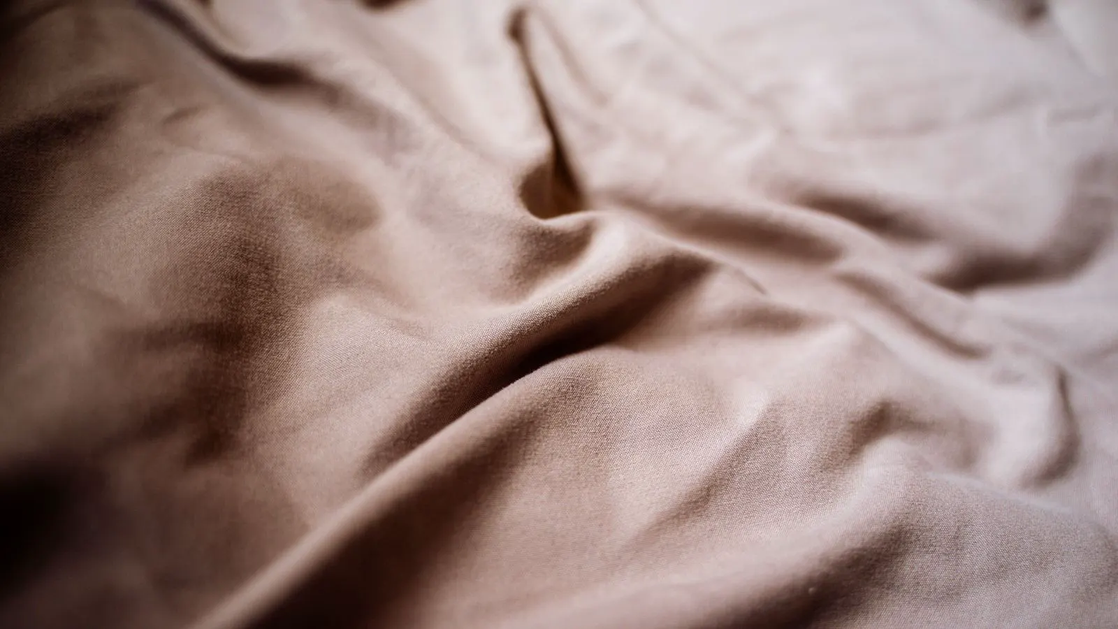 A damp white cotton shirt lying on a table with visible creases