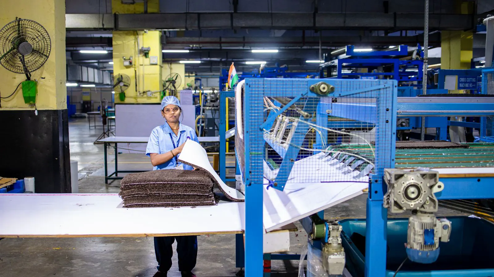Close view of a technician checking a nonwoven fabric sample against a checklist