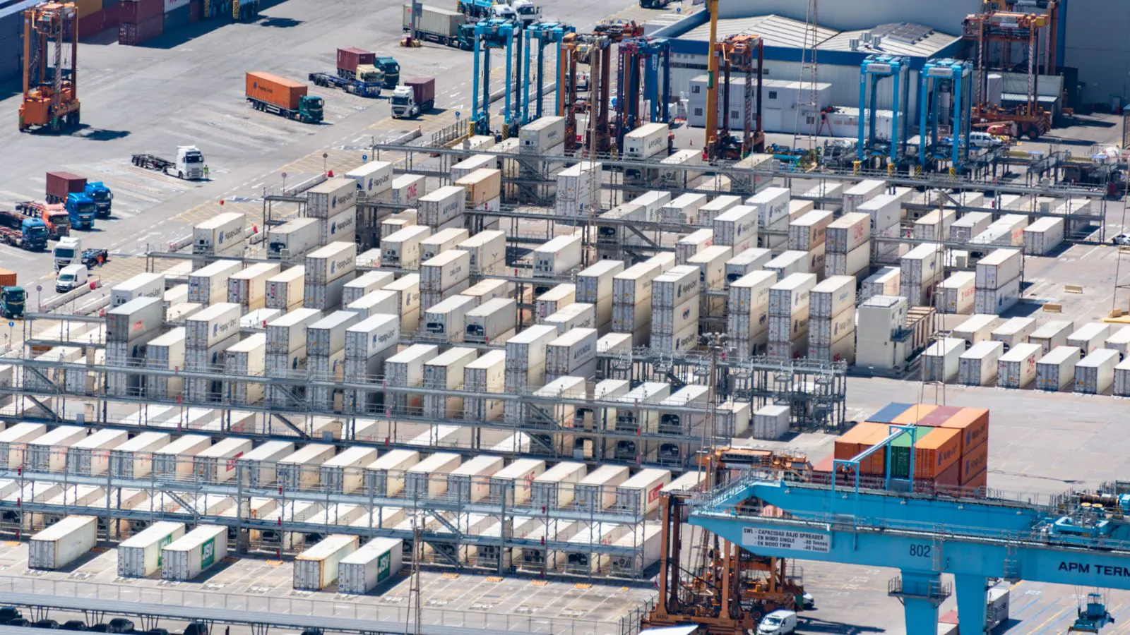 Stacked containers and fabric rolls inside a logistics warehouse