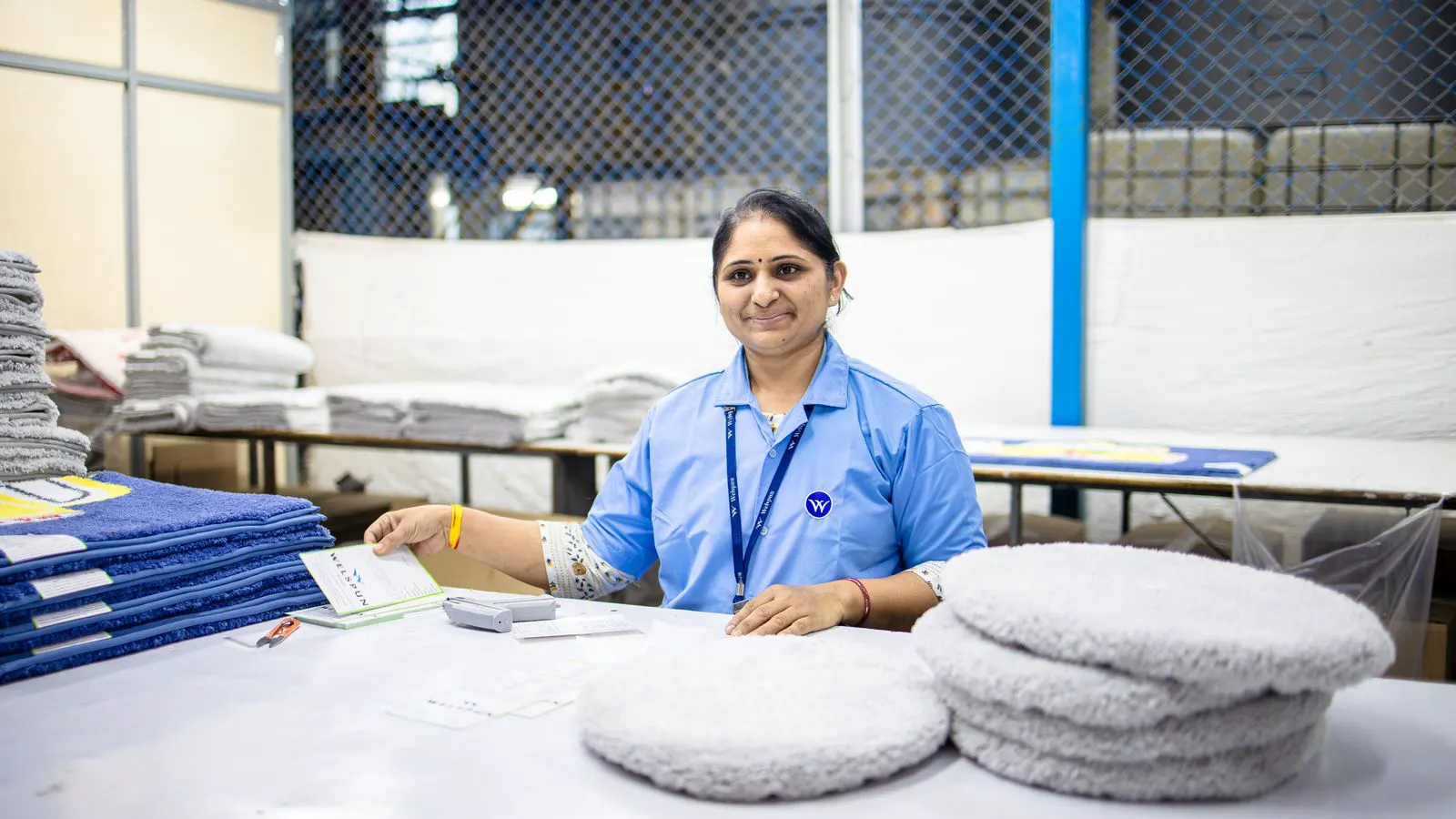 Quality inspector checking a roll of nonwoven fabric in a production area.