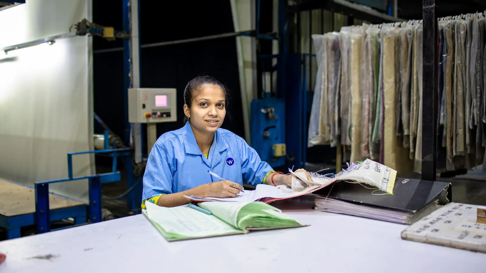 A factory manager reviews a cost quote and invoice side by side